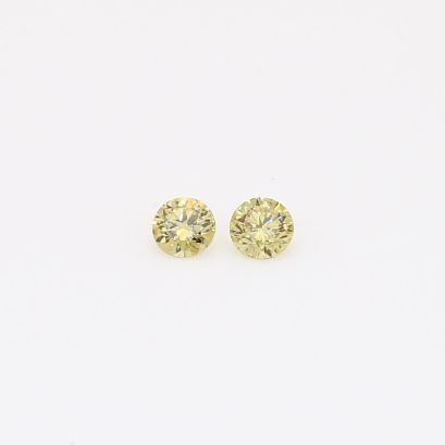 0.10 Total carat pair of round-cut fancy yellow diamonds
